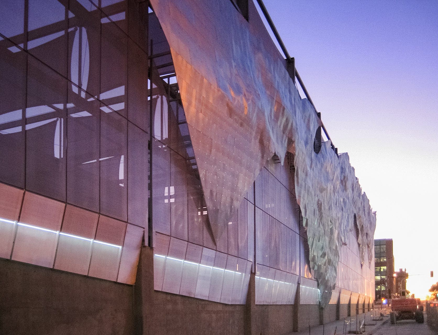 Dusk photograph of the Winds of Aphrodite artwork on Bartle Hall Loading Dock.