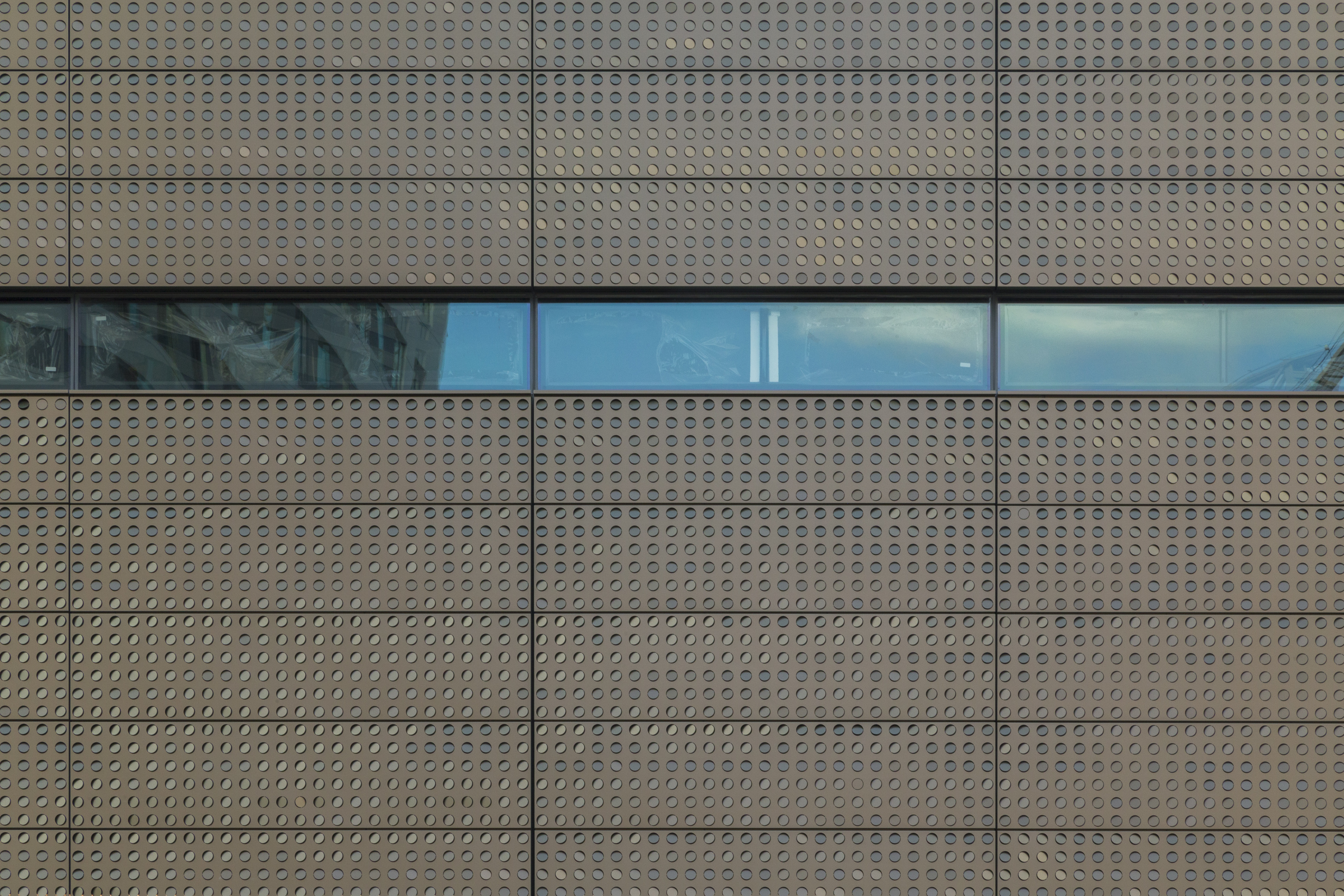 Color-shifting painted aluminum moves between bronze and green color-tones.