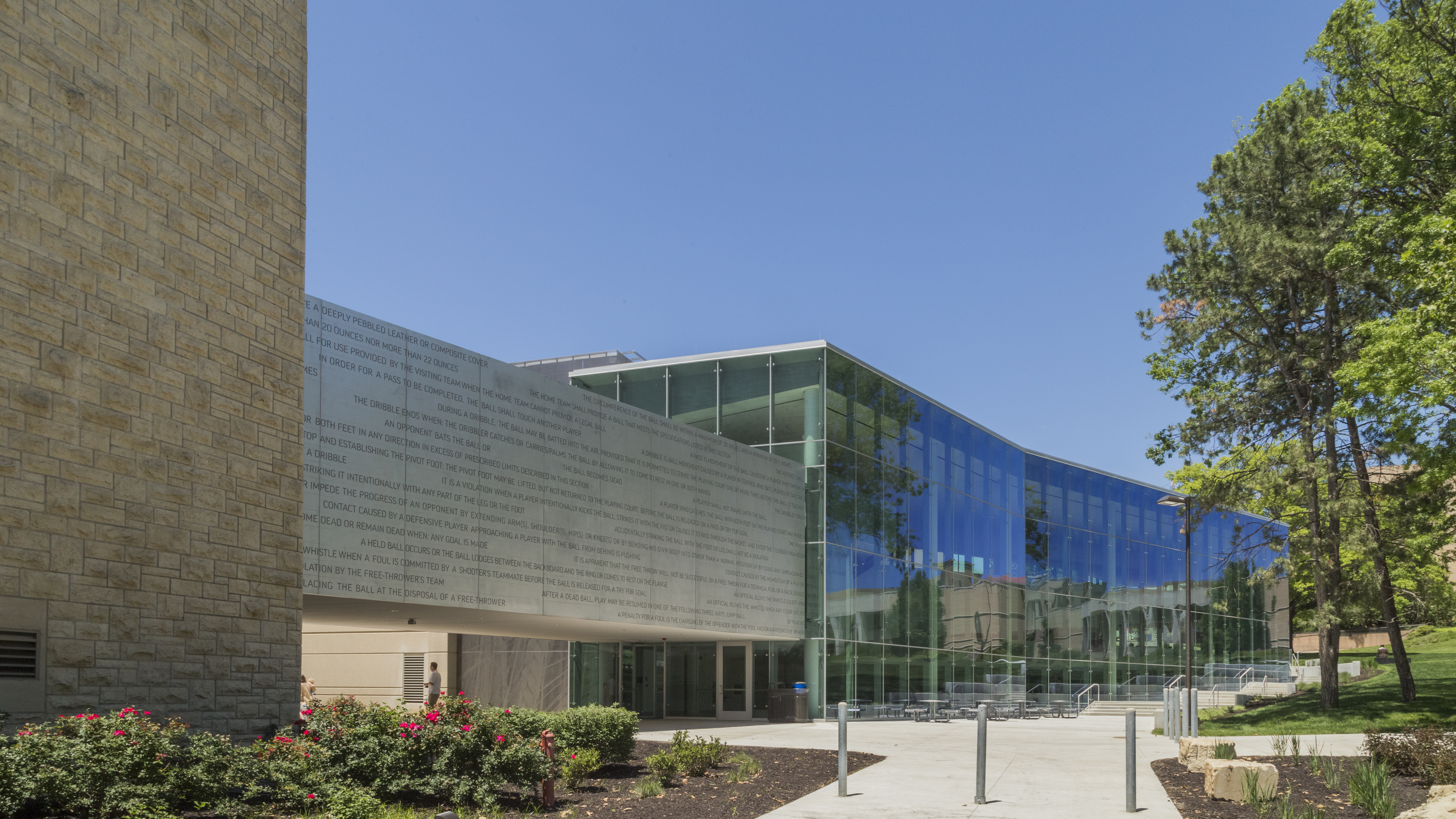 The Allen Fieldhouse (left) is connected to the DeBruce Center via an aluminum clad pedestrian bridge.