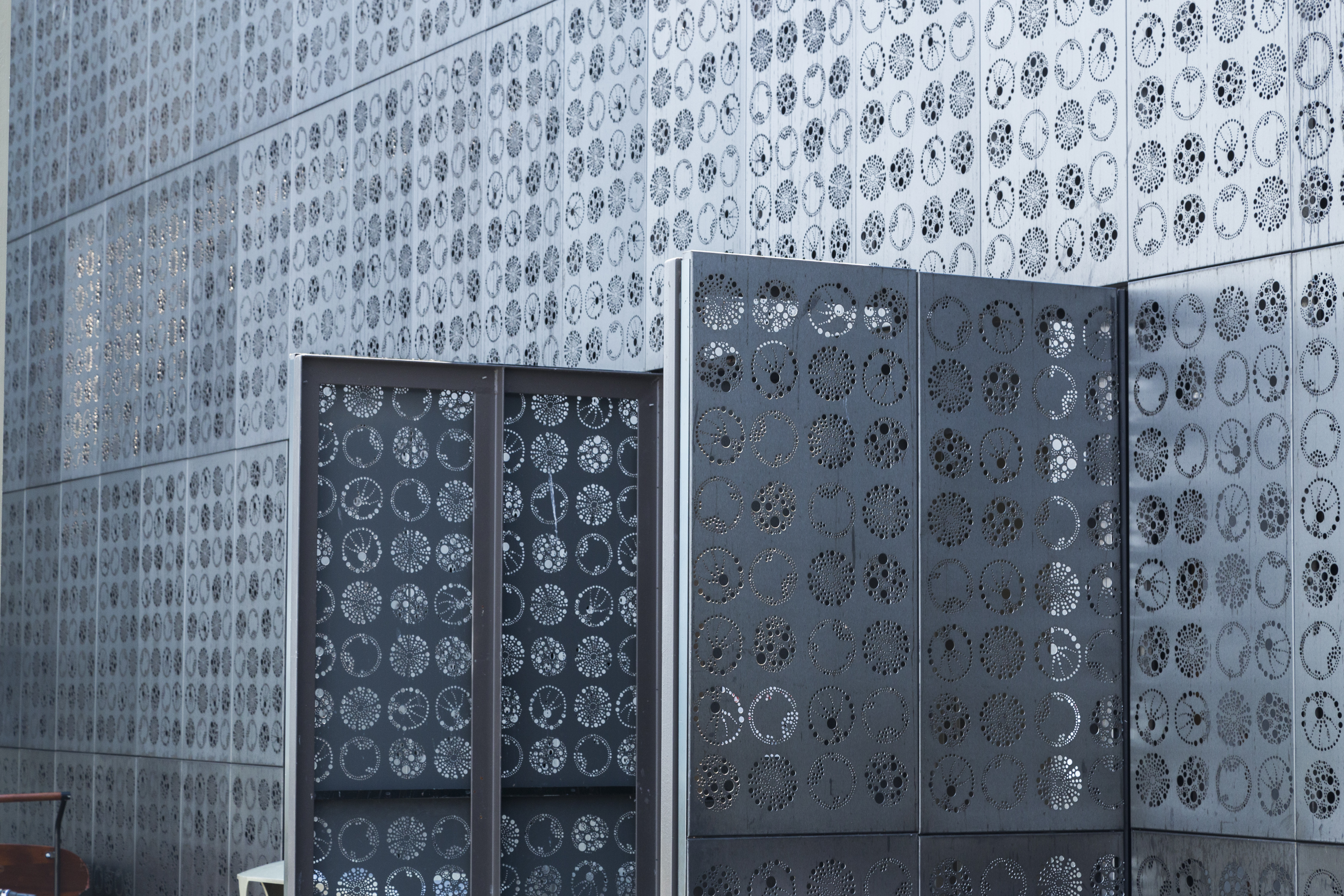 Operable doors clad in the Zahner perforated metal open to the ocean bay.