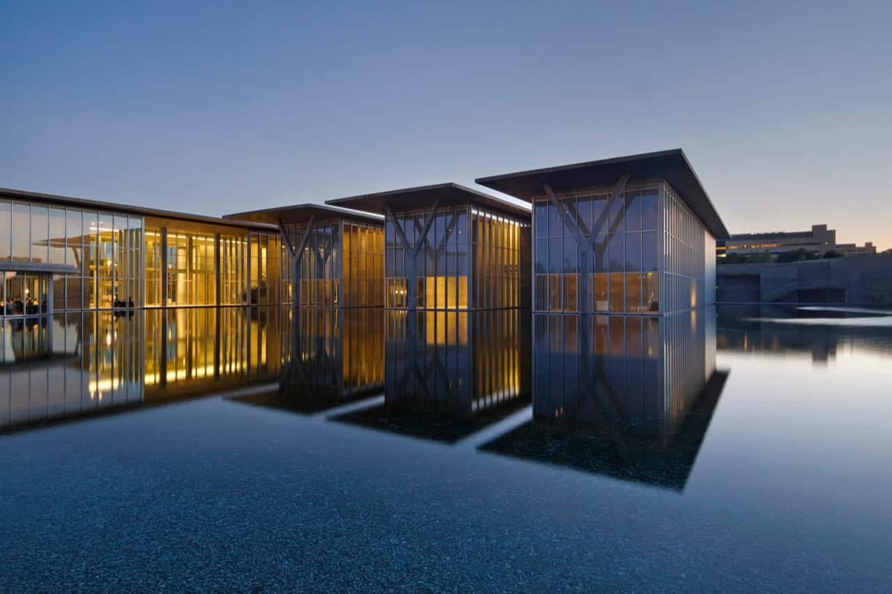 The reflected image of The Modern Art Museum at dusk.