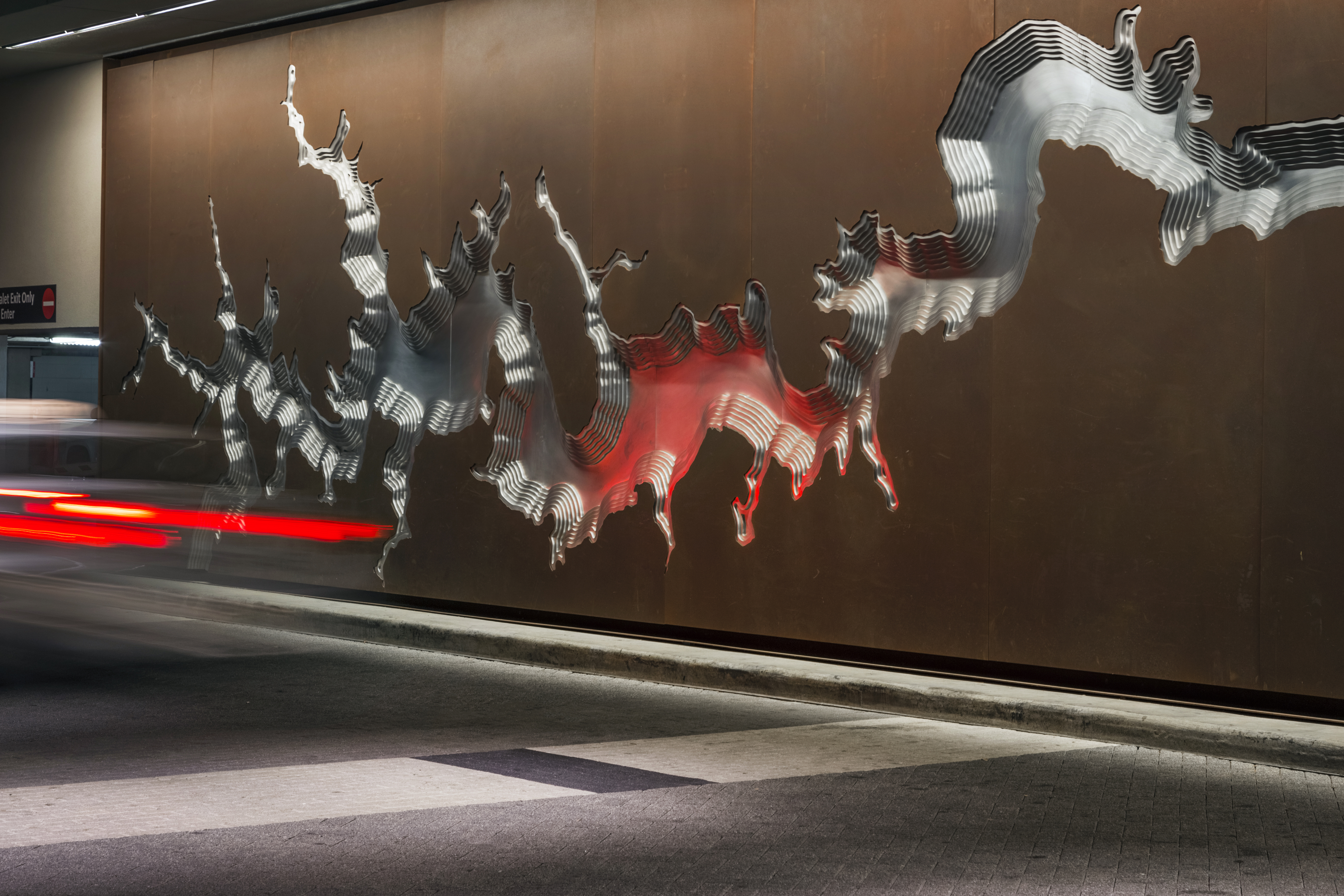Light reflects against the aluminum artwork.