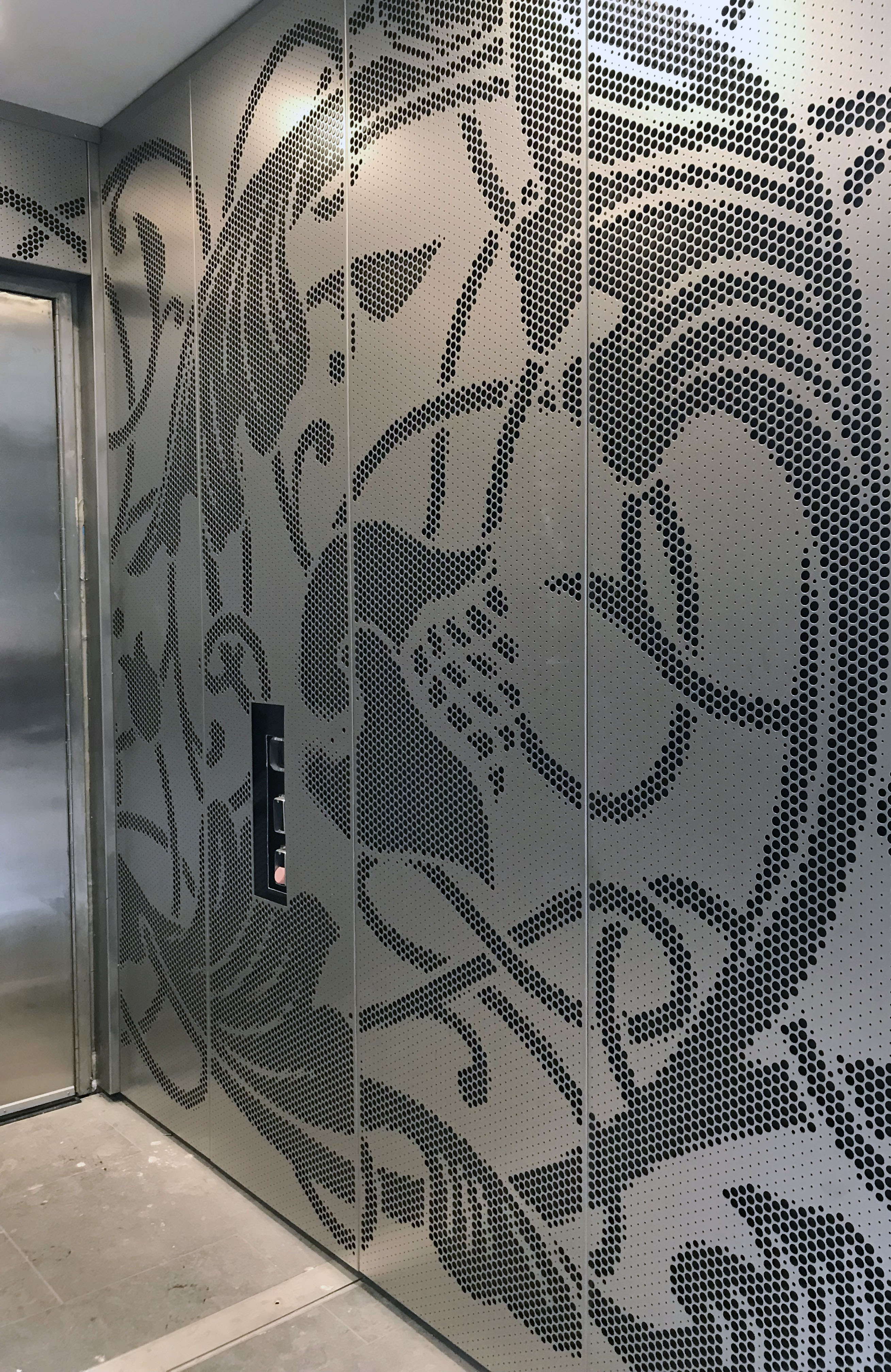 Installation of an ImageWall custom perforated panel system, a Zahner patented process.