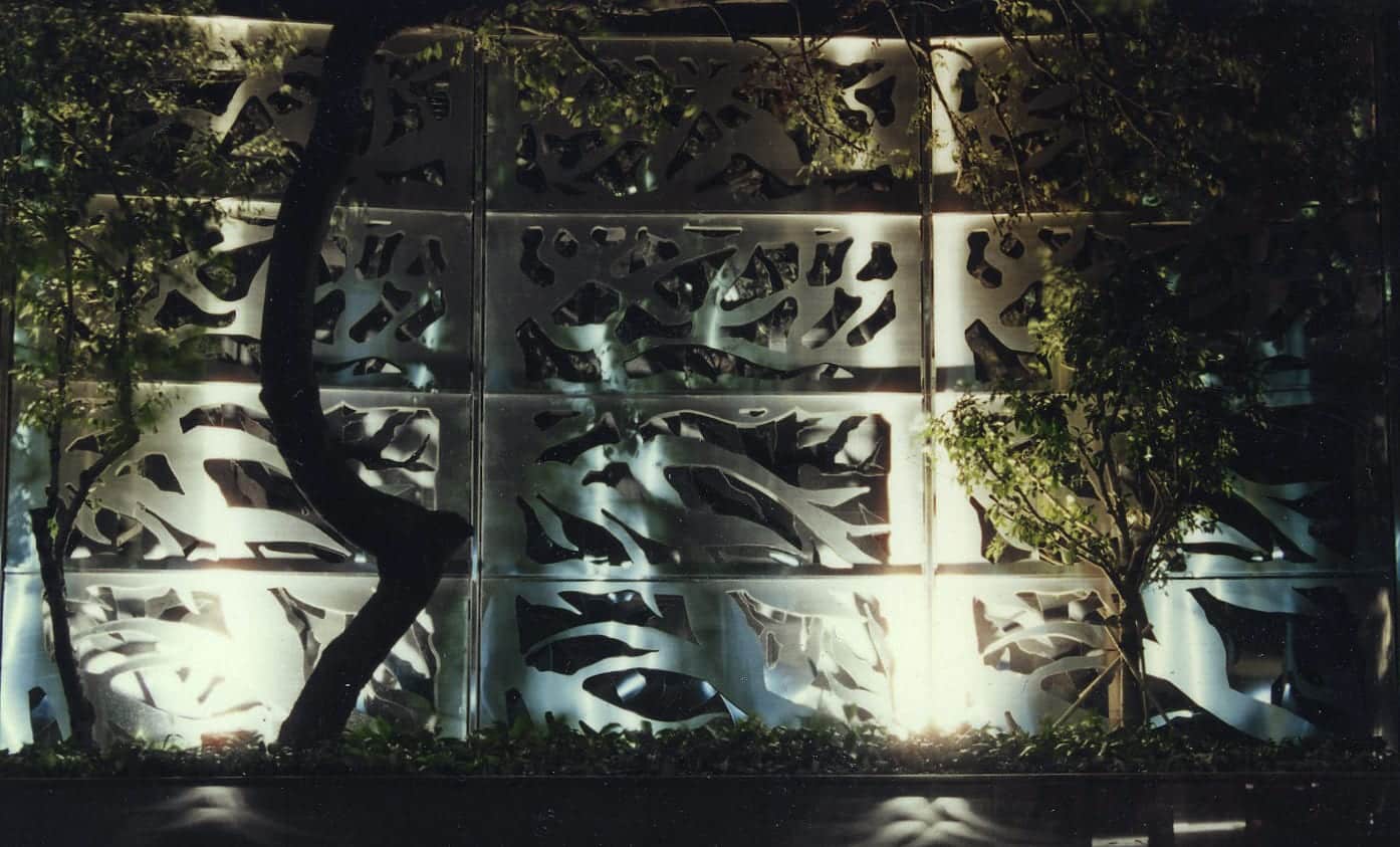 Photograph at night of the stainless steel art wall at Carmen's Garden in Hong Kong.