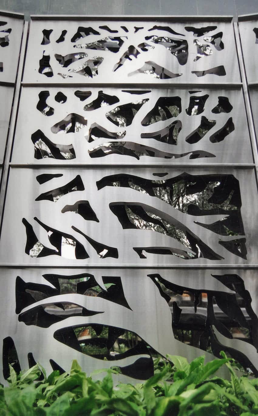 Detail of the custom laser-cut stainless steel panels at Carmen's Garden.