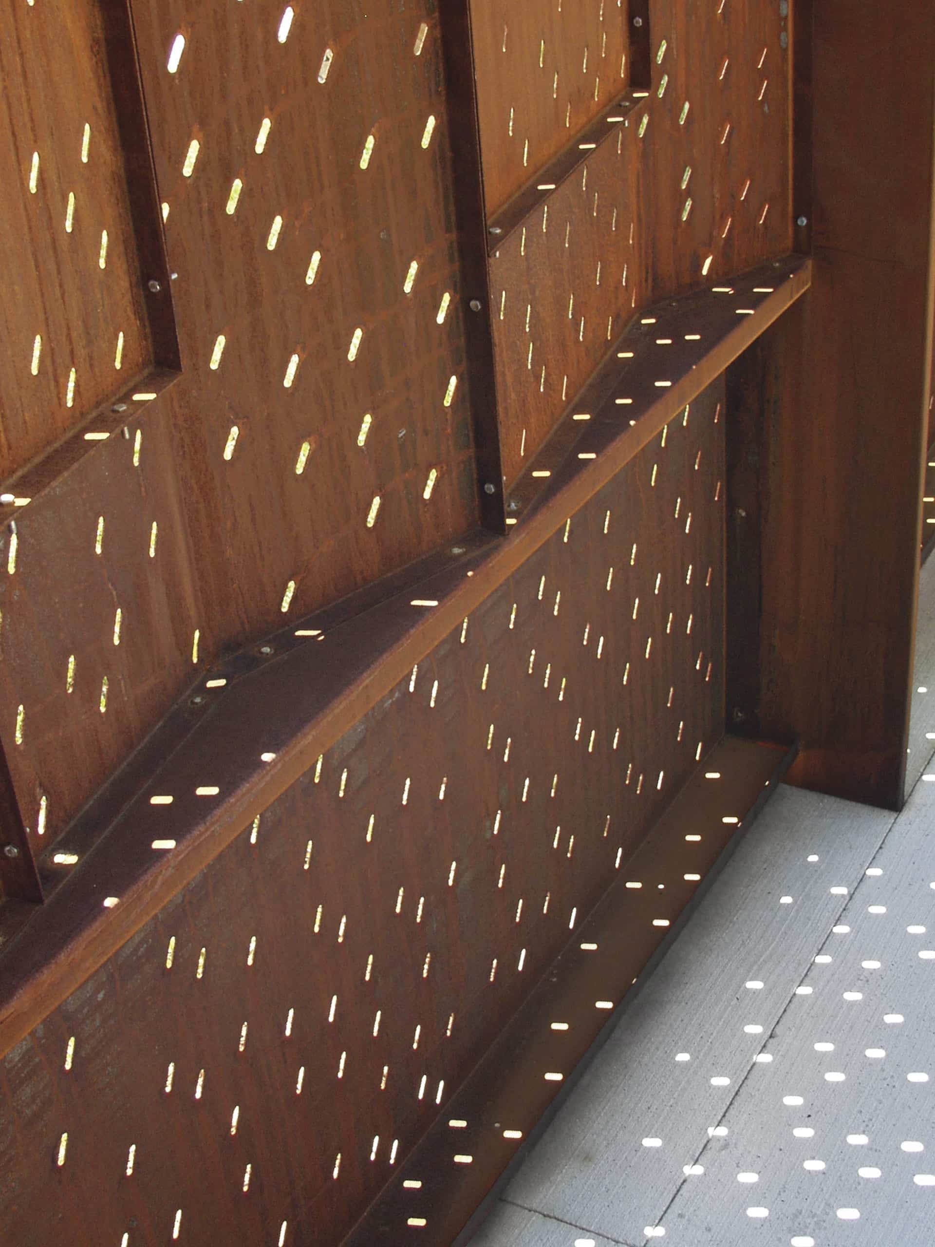 Custom obround die-shapes were used to create the oval perforation patterns in the weathering steel.