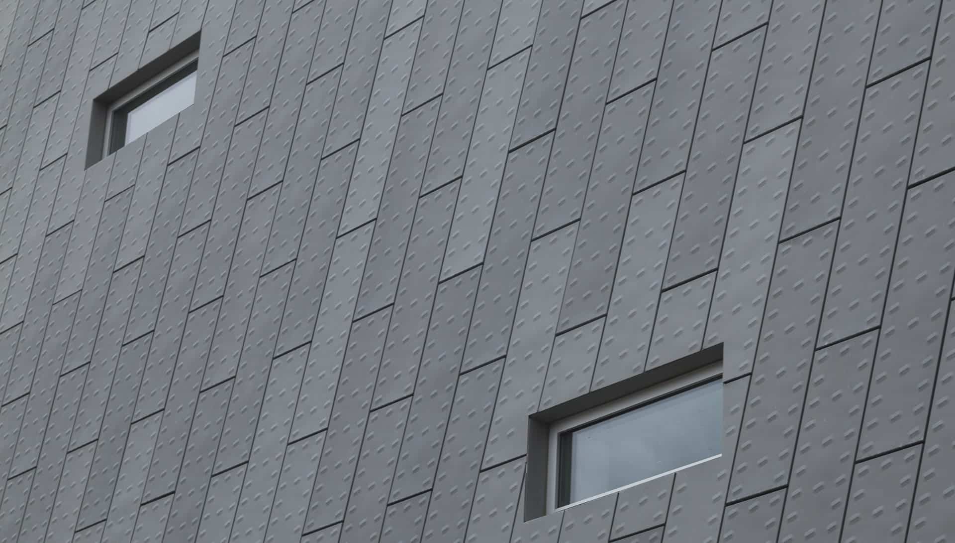 Detail of the punched and custom-embossed zinc exterior facade at KCPD Headquarters.