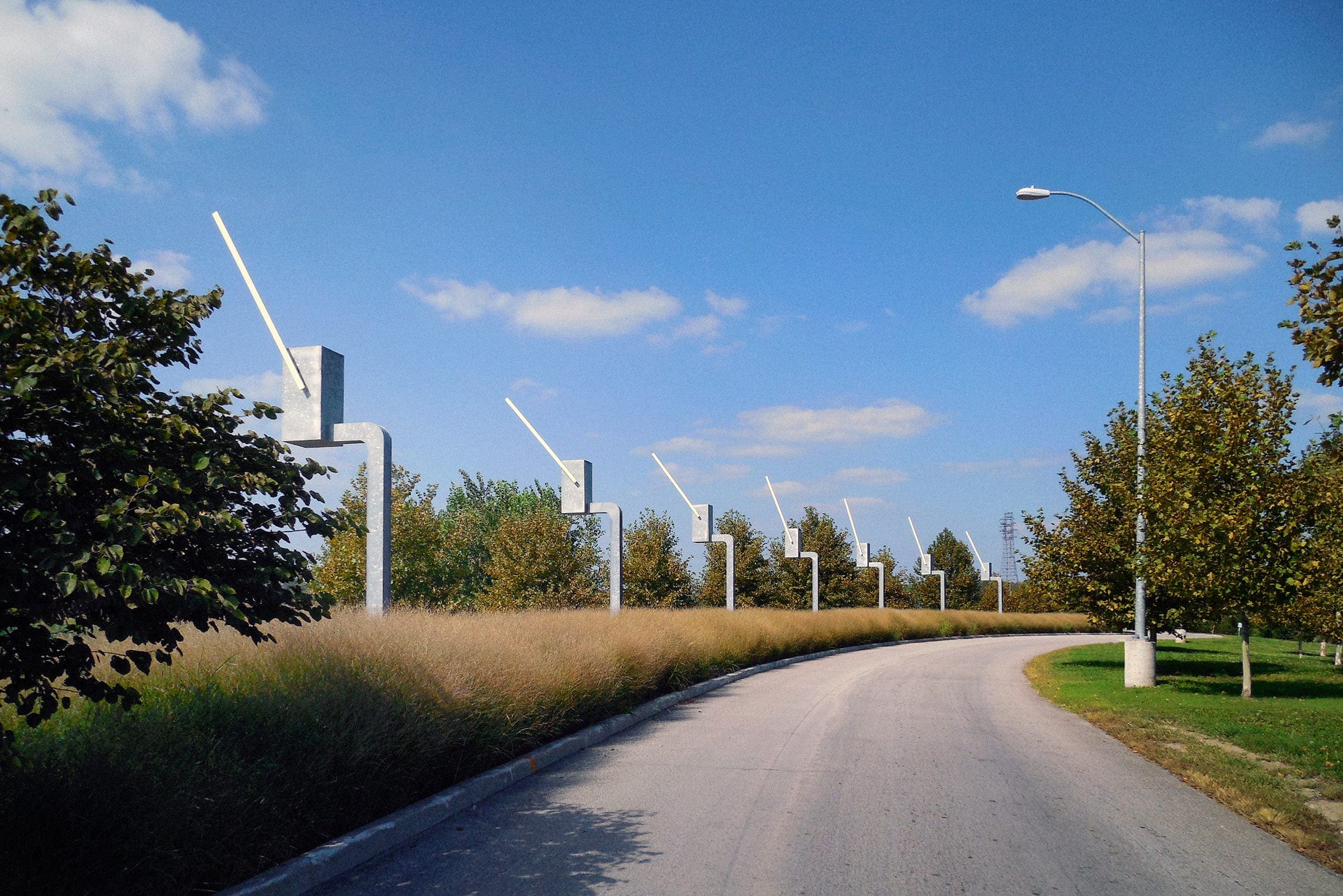 Seven Sentinels kinetic sculpture made in galvanized steel. Each of the parking gate sculptures salute exiting drivers.