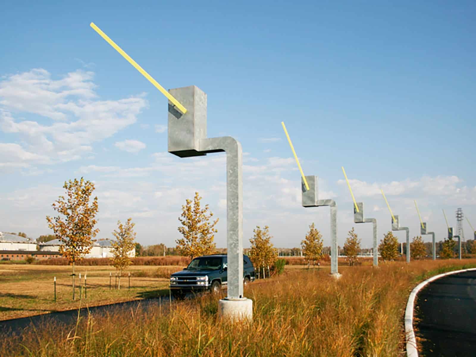 Seven Sentinels kinetic sculpture. Each of the parking gate sculptures salute exiting drivers.