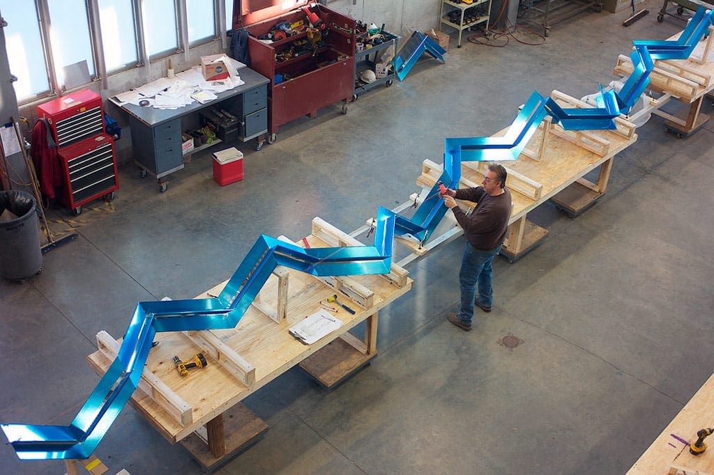 Zahner shop personnel make measurements to align the Regazzoni sculpture.