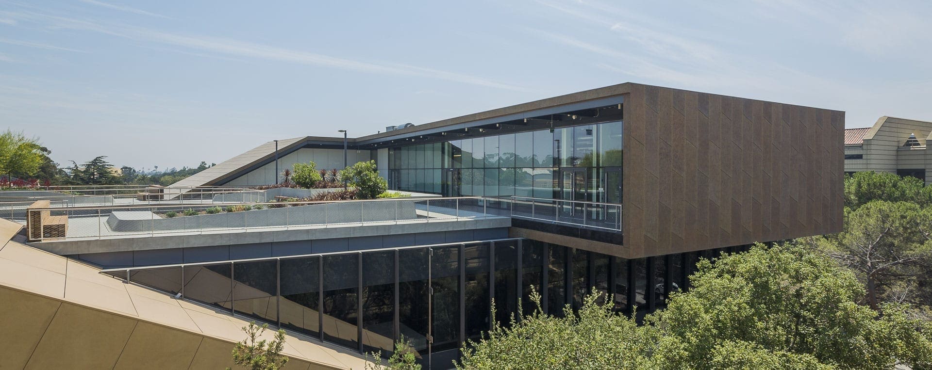 The building's cantilevered form highlights the rooftop area's custom patina on zinc.