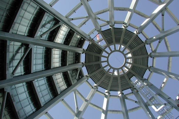 Upward view from inside the cone during the construction of Museum of Glass. The left side of this picture, photographed during construction, shows the final surface of the exposed panels. The right side of the photograph shows the the sky filtered through the unfinished understructure of the cone.