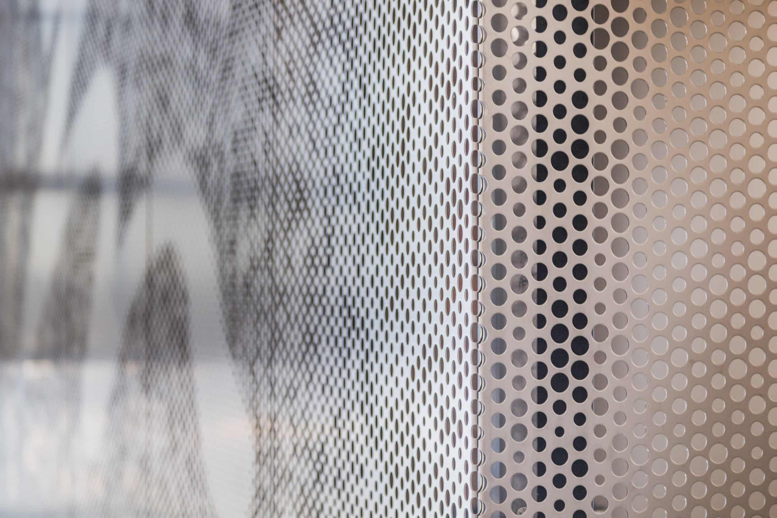 Free-standing screen in Angel Hair Stainless Steel with a painted aluminum backing for office lobby.