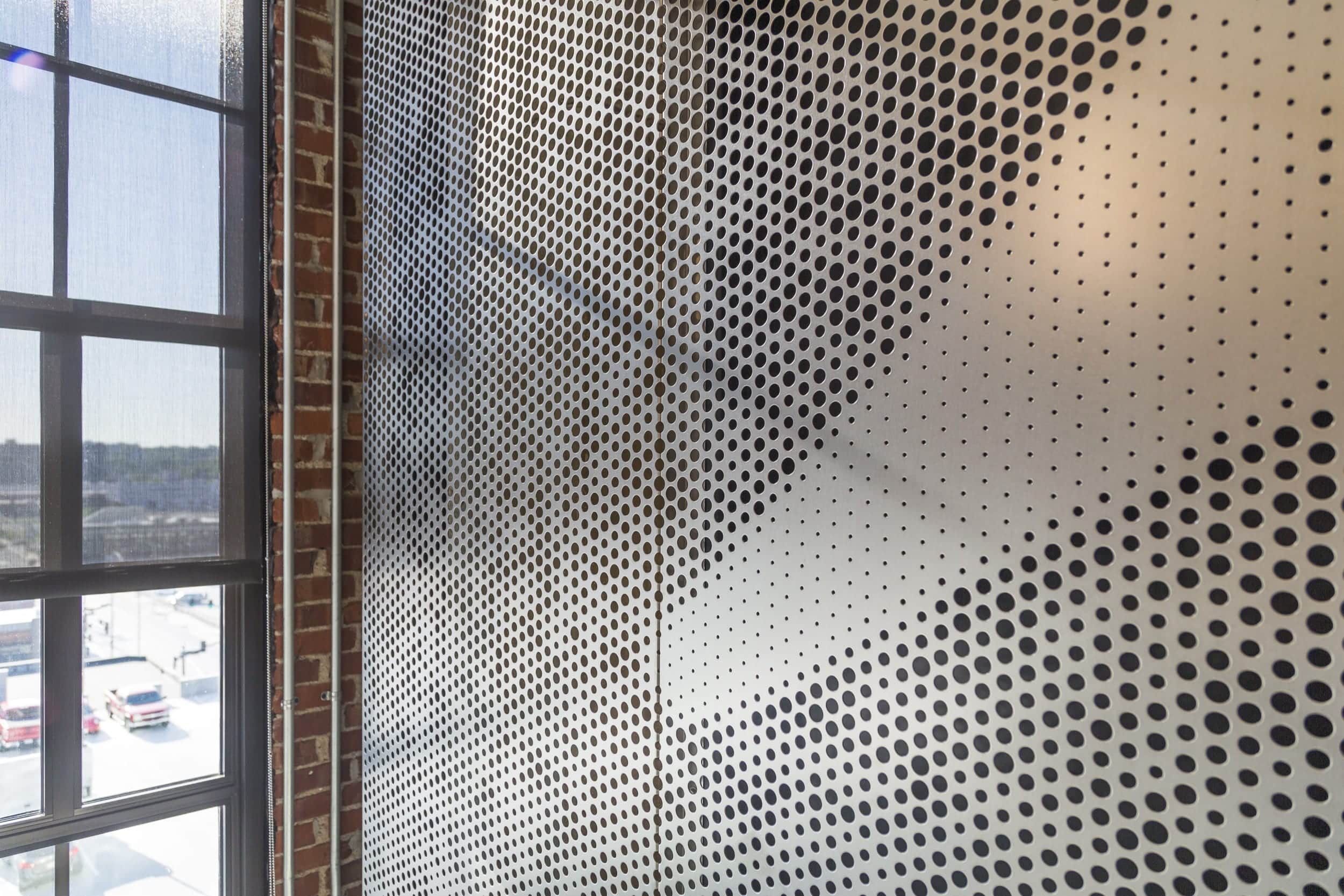 Free-standing screen in Angel Hair Stainless Steel with a painted aluminum backing for office lobby.
