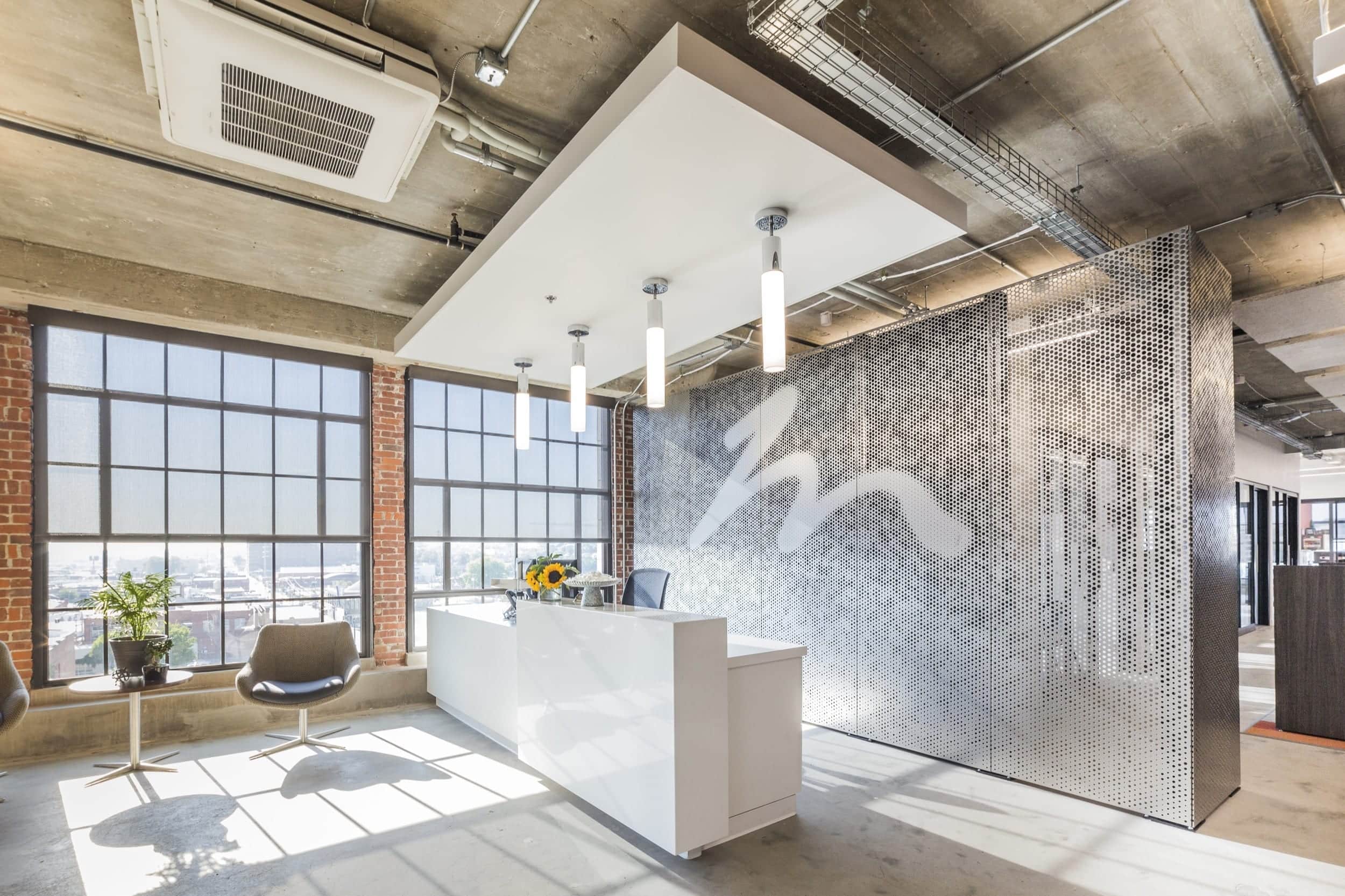 Free-standing screen in Angel Hair Stainless Steel with a painted aluminum backing for office lobby.