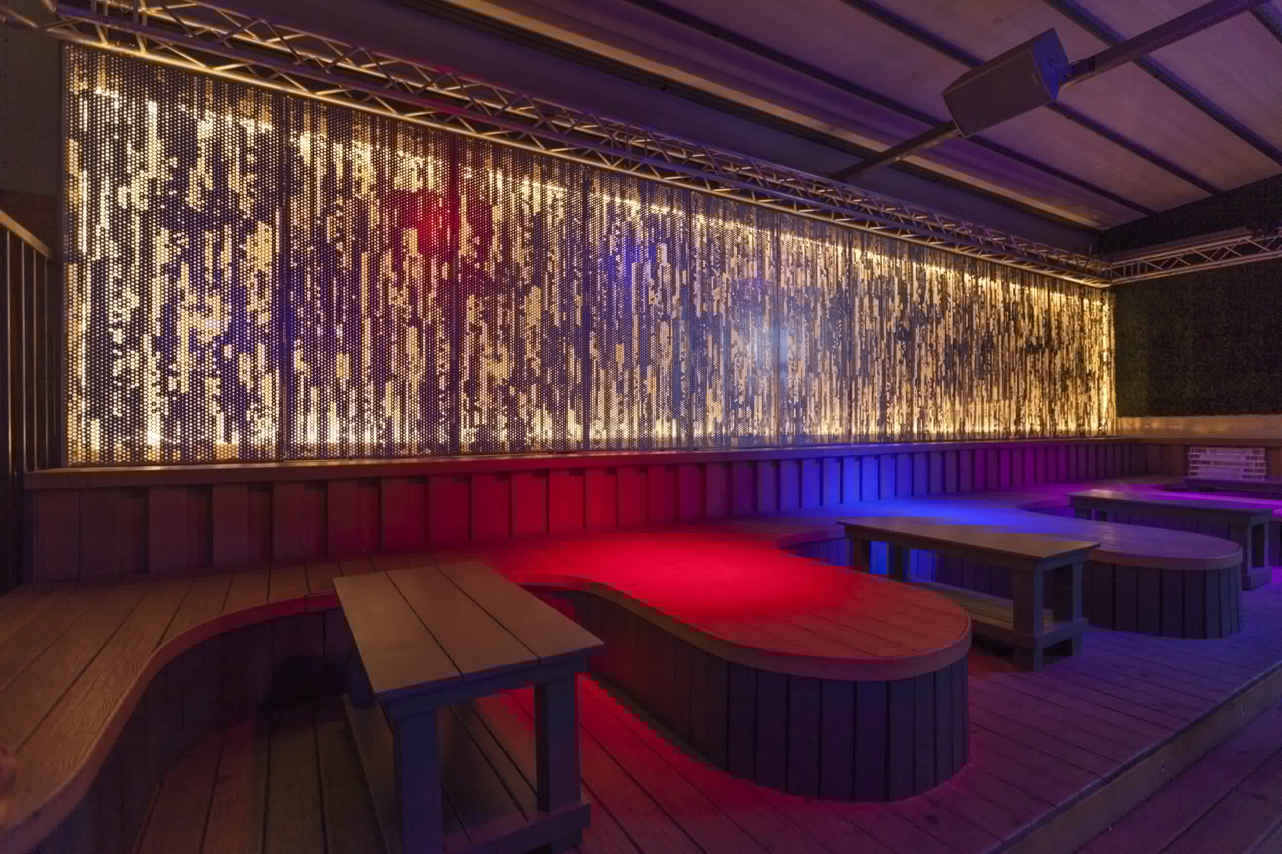 An illuminated ImageWall screen provides a dramatic backdrop for an event space