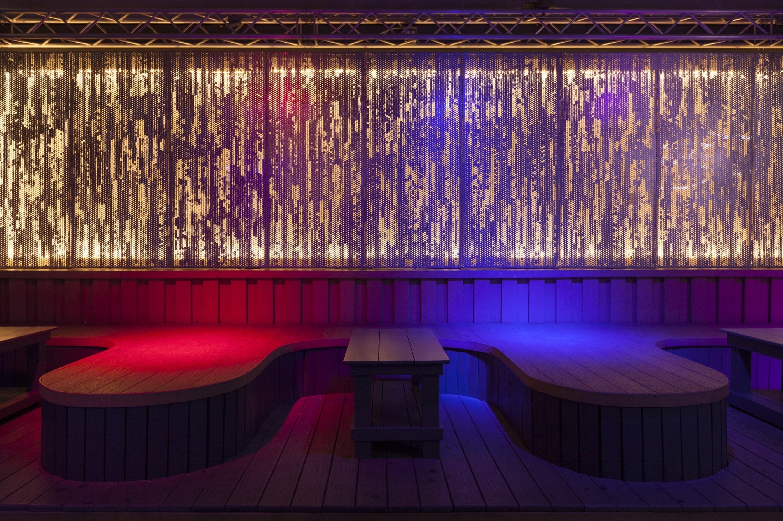 An illuminated ImageWall screen provides a dramatic backdrop for an event space