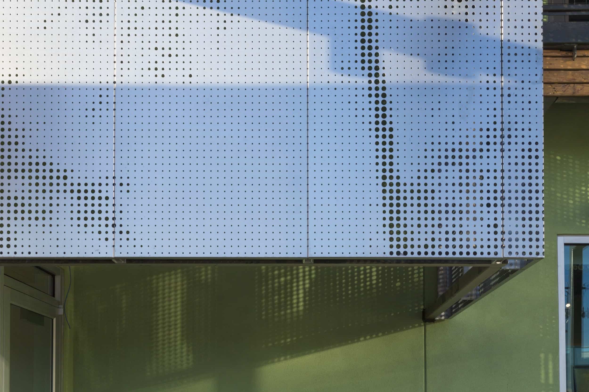 Restaurant facade and ImageWall screen in angel hair stainless steel with imagery of tree branches.