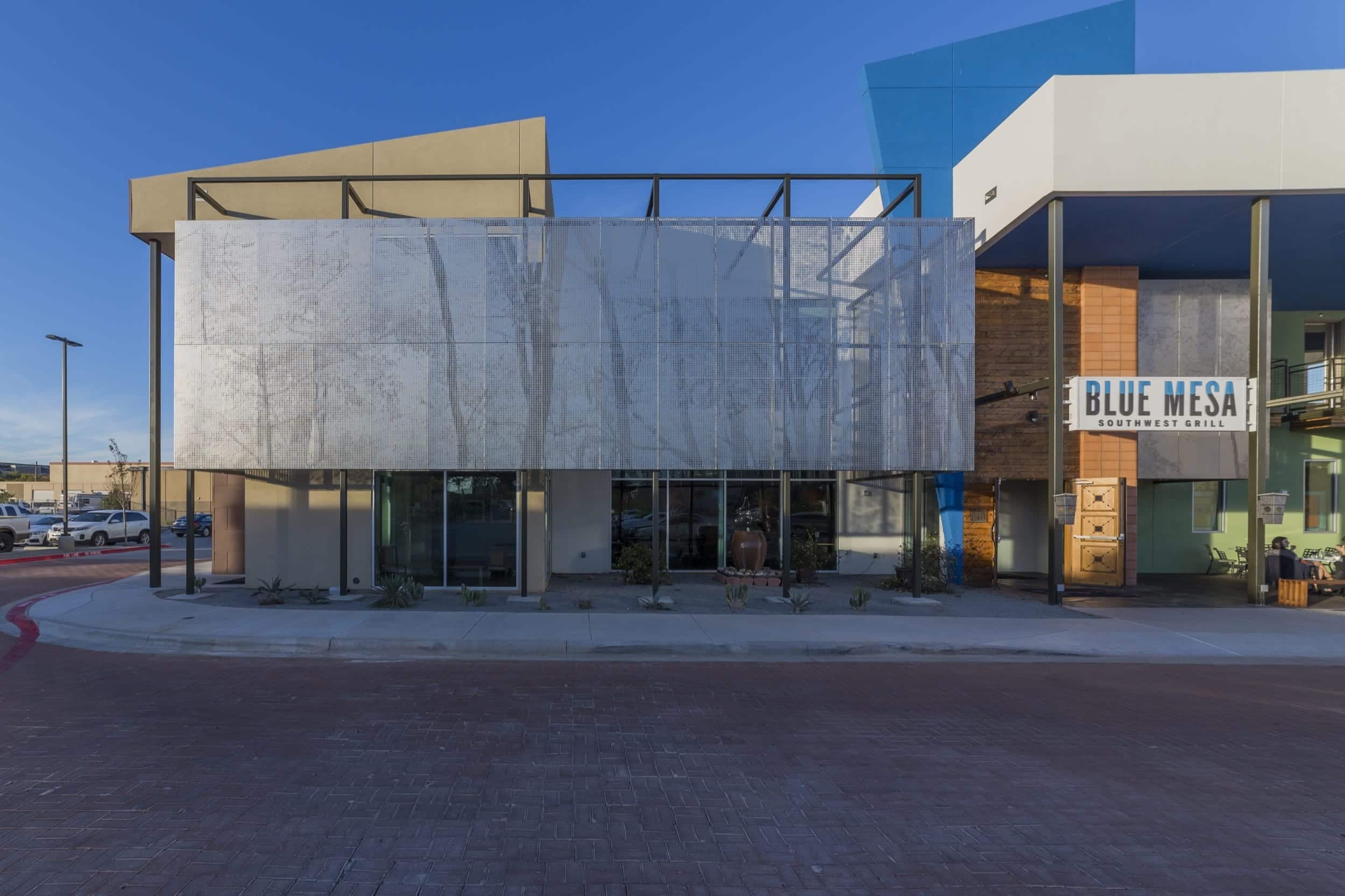 Restaurant facade and ImageWall screen in angel hair stainless steel with imagery of tree branches.