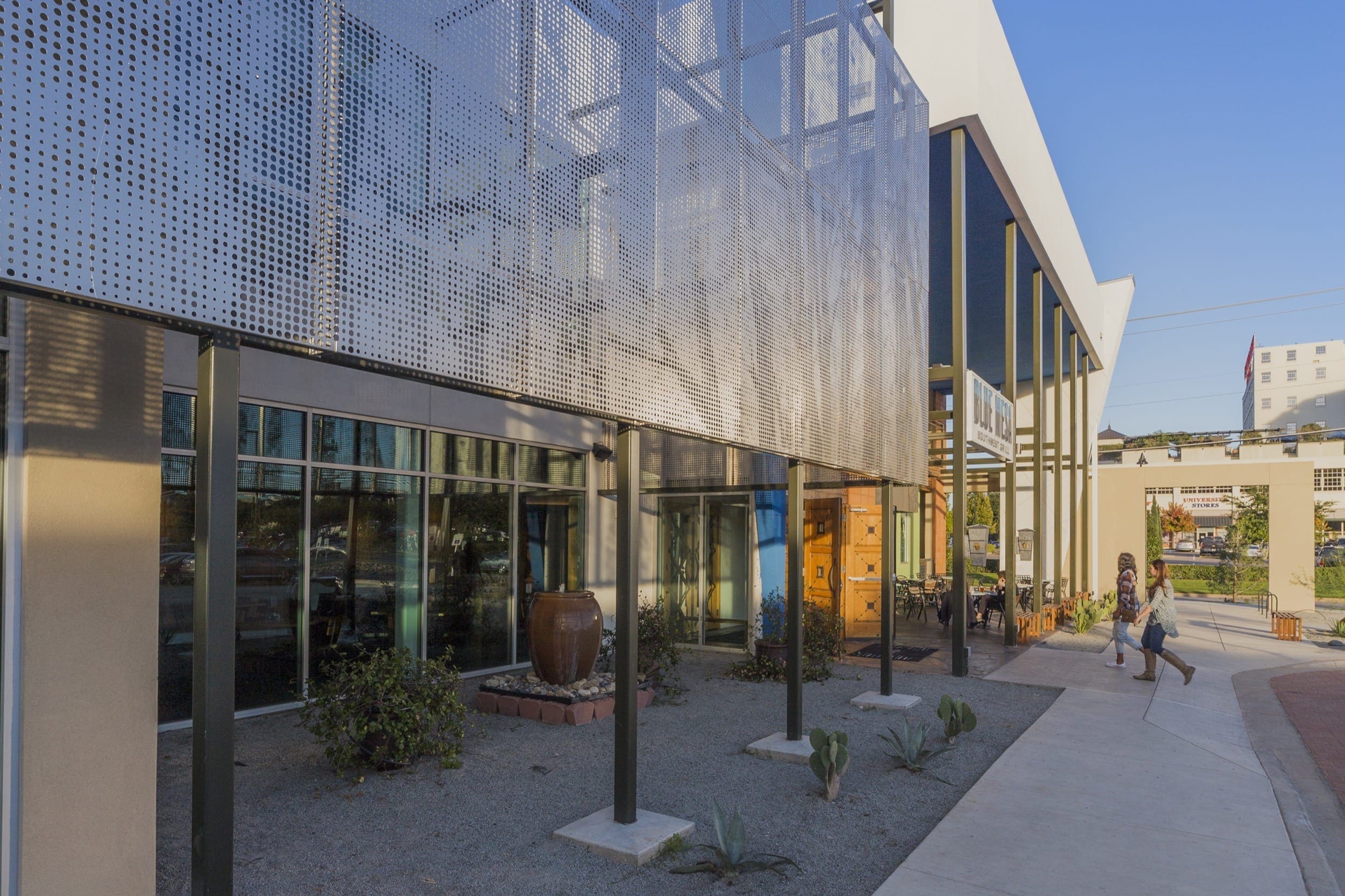 Restaurant facade and ImageWall screen in angel hair stainless steel with imagery of tree branches.
