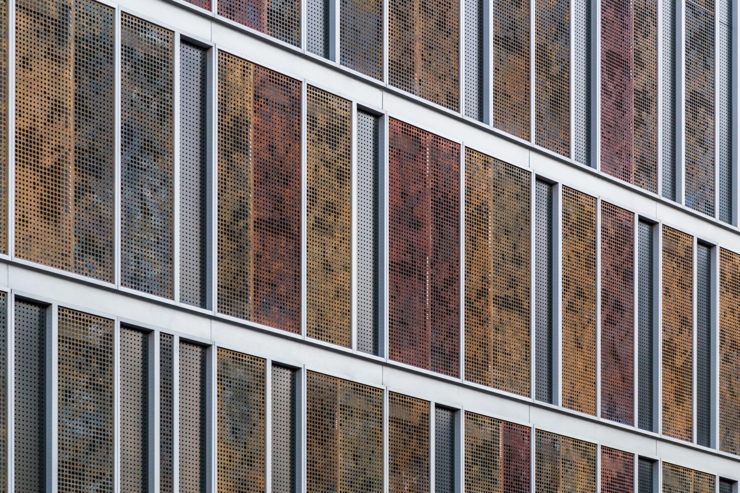 Custom patinated zinc and aluminum panels adorn the parking facade for Children's Hospital Richmond Pavilion.