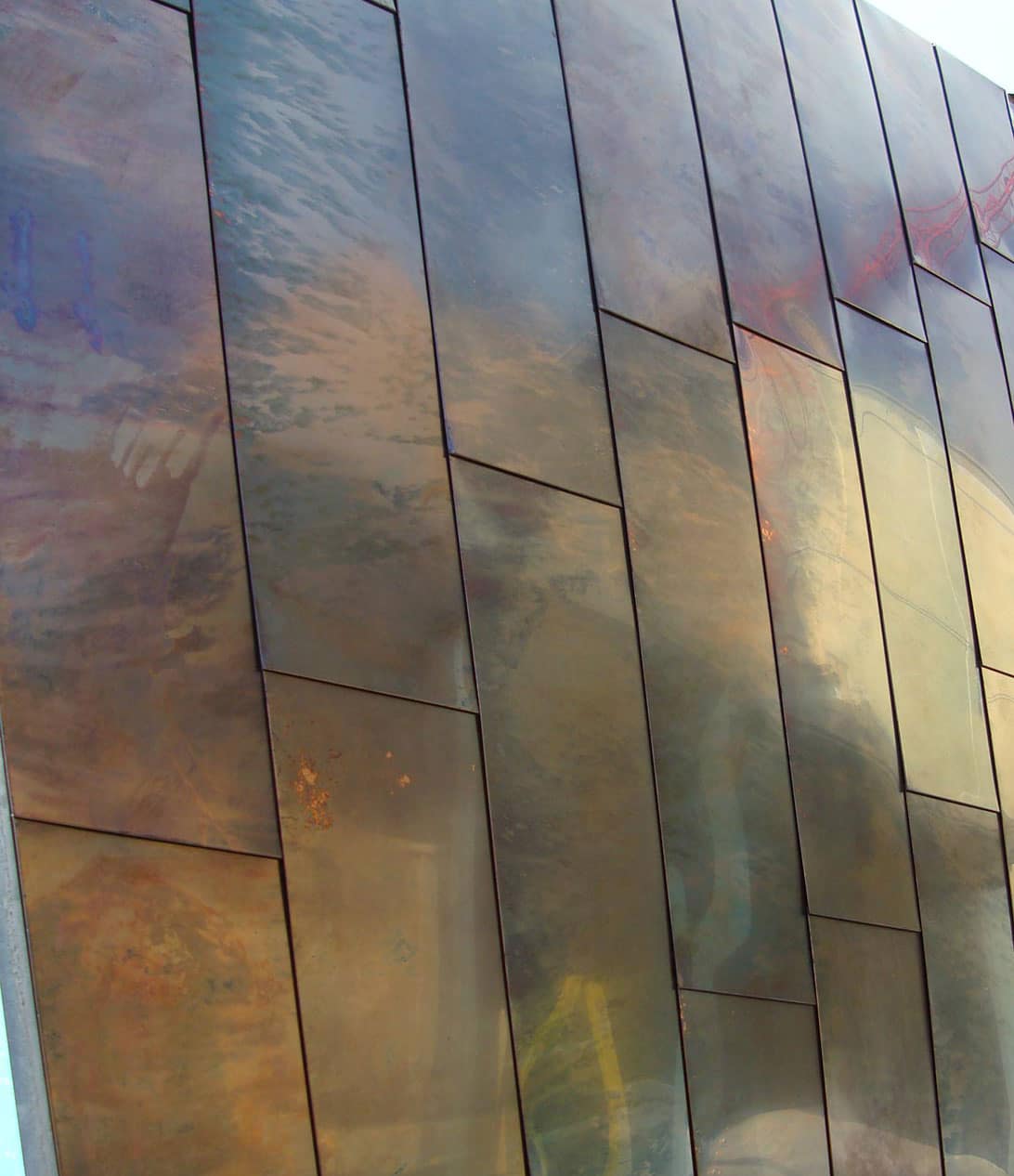 DETAIL OF THE DIRTY PENNY PATINA ON COPPER PANELS